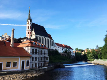 River amidst buildings against sky