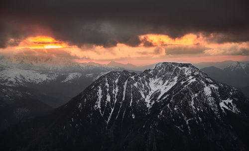 Scenic view of snowcapped mountains against sky during sunset