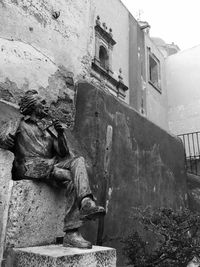 Low angle view of statue against building