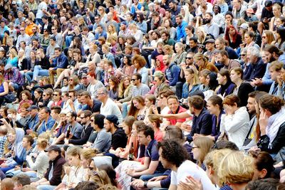 Crowded audience sitting in stadium