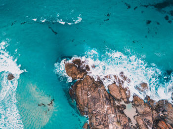 High angle view of rocks by sea