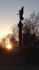 Low angle view of statue against sky