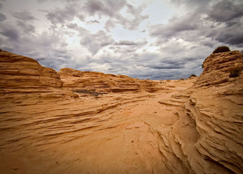 Rock formations against cloudy sky at mungo national park