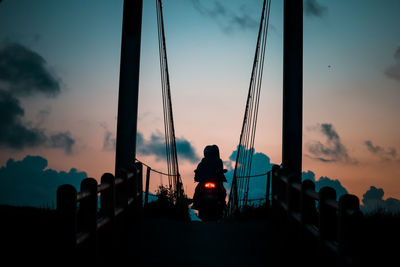 Low angle view of silhouette man standing against sky during sunset