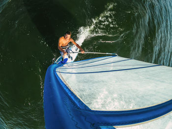 High angle view of man on boat in sea