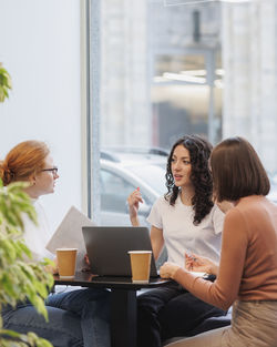 Woman with colleagues sitting at table