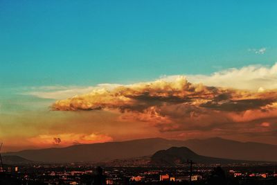 Scenic view of silhouette mountains against sky at sunset