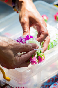 Cropped hands holding flowers