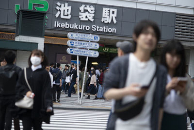 People walking on railroad station platform