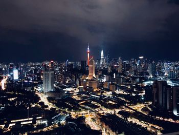 High angle view of illuminated buildings against sky at night