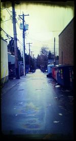 Empty road leading to building