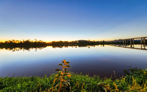 Scenic view of lake against clear blue sky