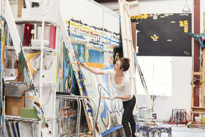 Young woman painting in art studio