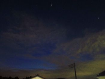 Low angle view of silhouette vapor trails in sky