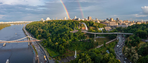Panoramic view of kyiv city with a beautiful rainbow over the city.