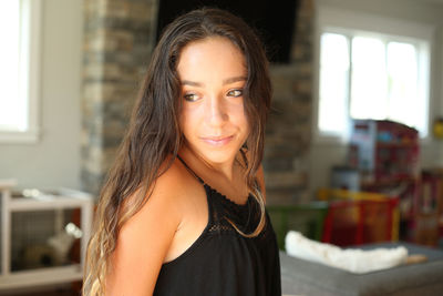 Portrait of smiling young woman standing outdoors