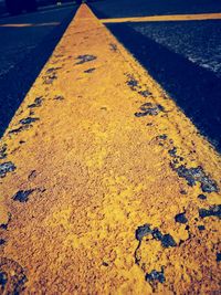 High angle view of yellow marking on road