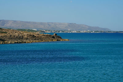 Scenic view of sea against clear blue sky