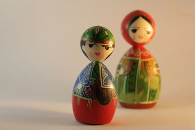 Close-up of toys on table against colored background