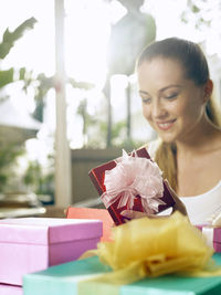 Smiling woman looking at gifts in restaurant