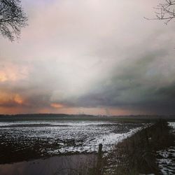 Scenic view of sea against cloudy sky