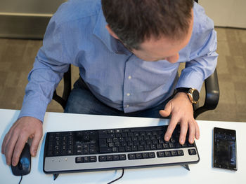 High angle view of man using mobile phone