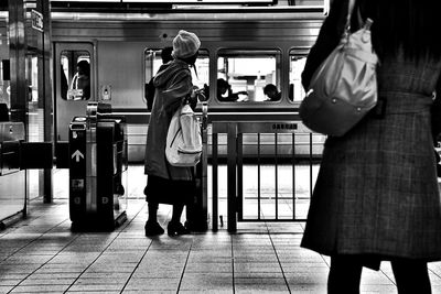 Rear view of people walking in subway