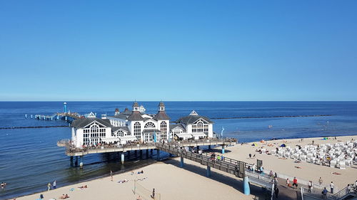 High angle view of sea against clear blue sky