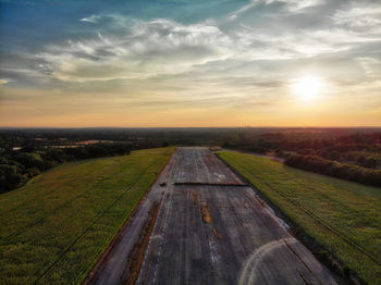 Scenic view of land against sky during sunset