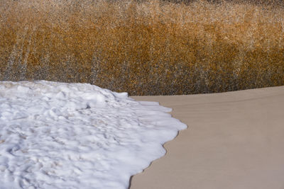 High angle view of frozen water on land