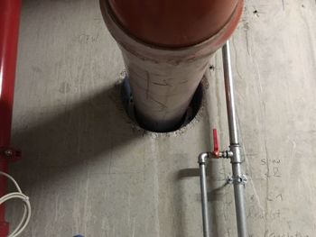 High angle view of pipe on table against wall