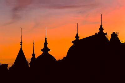 Silhouette of temple building against sky during sunset