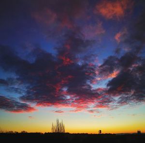 Scenic view of dramatic sky over silhouette landscape