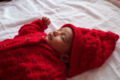 High angle view of baby sleeping on bed