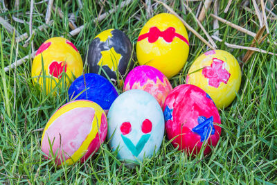 High angle view of multi colored eggs on grass