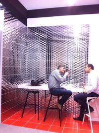 Rear view of young woman sitting on chair