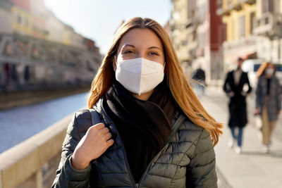 Portrait of woman wearing mask on street