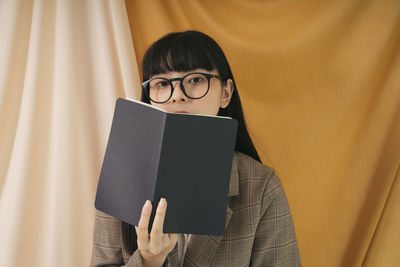 Portrait of woman holding book