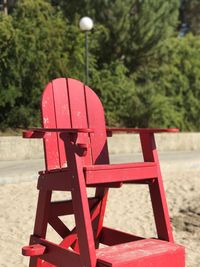 Close-up of empty bench in park