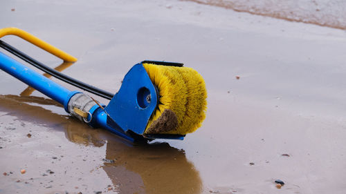 High angle view of yellow toy on sand