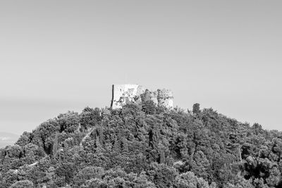 Low angle view of castle on hill against clear sky
