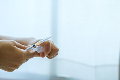 Close-up of hand holding umbrella