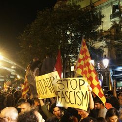 People holding flag in city at night