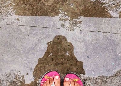 Low section of person standing on tiled floor