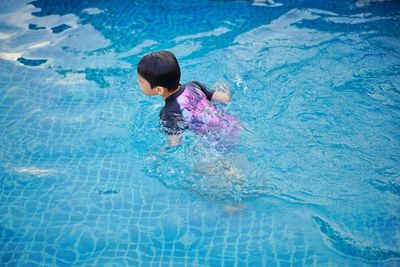 High angle view of boy swimming in pool