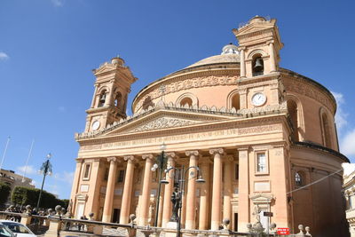 Low angle view of historical building against blue sky