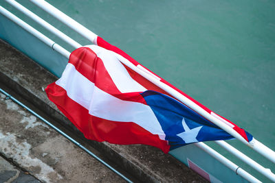 Close-up of flag against boat in water