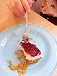 Cropped image of woman eating cake