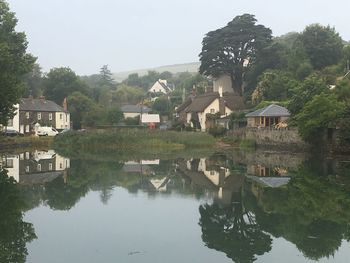 Scenic view of lake with houses in background