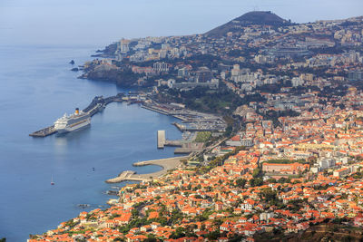 High angle view of townscape by sea